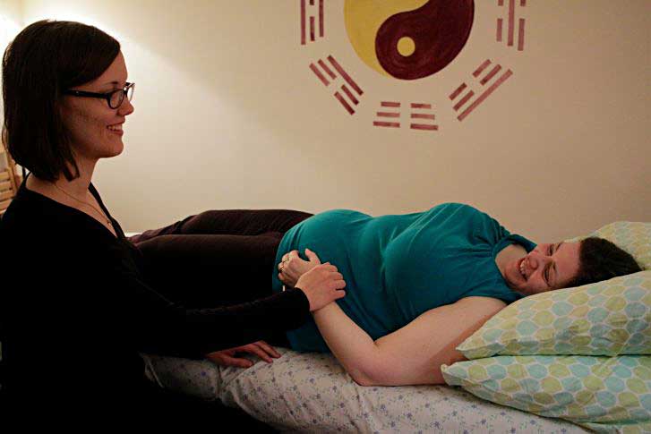 Lynn Palmgren taking the pulse of patient
